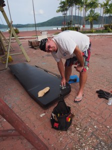 Me with the rebuilt centreboard.  Geez, if I had only put it in the right way the first time I would not have had to take it all apart again.  That was a three day delay!! Bad Tony. Always remember to dry fit.