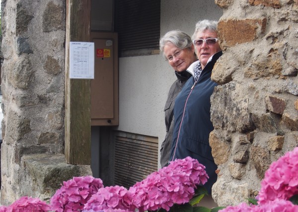 Sue and Connie waiting at the Saissac bus stop for the bus to Carcassonne