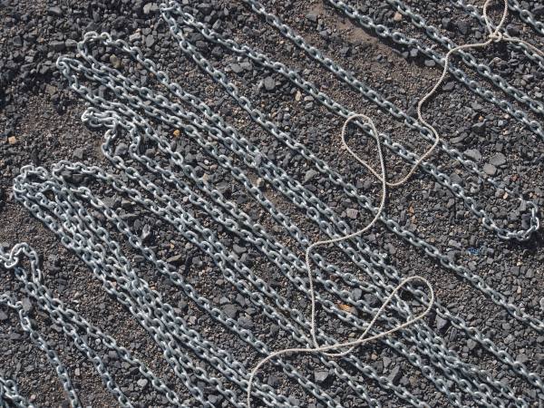 Newly galvanized chain flaked out for measuring and loading back onboard before launching