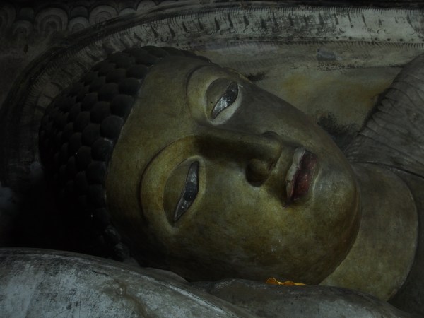 One of hundreds of Buddhas carved inside the caves of Dambulla