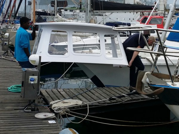 Struggling down the dock to get on with the installation